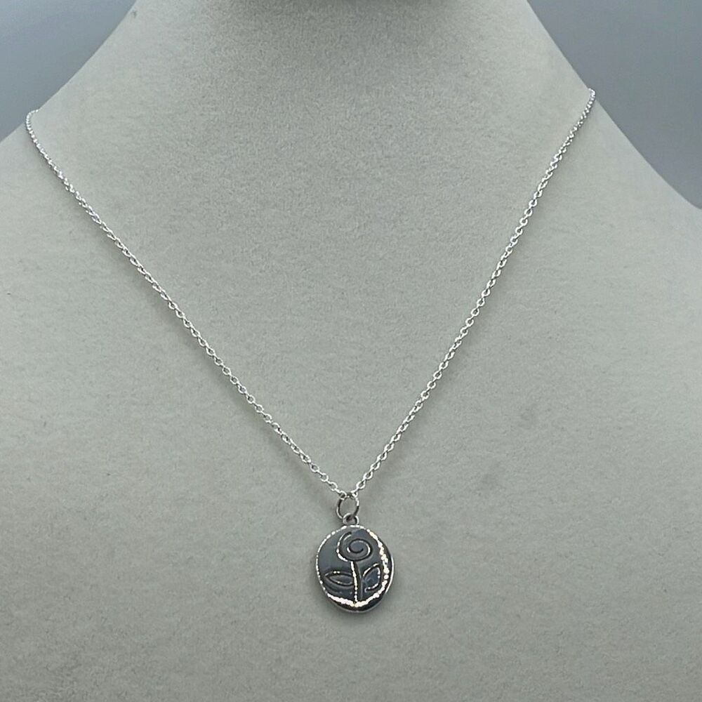 Sterling silver laser cut rose pendant necklace.